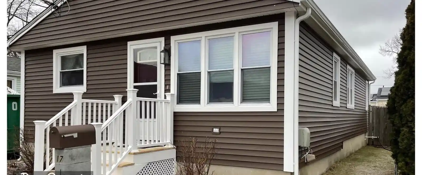 The back corner of a North Providence home after new siding and trim were installed, showing the finished trim around the corner posts.