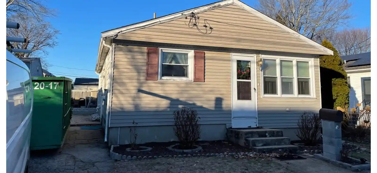 Before: the North Providence house with faded beige siding