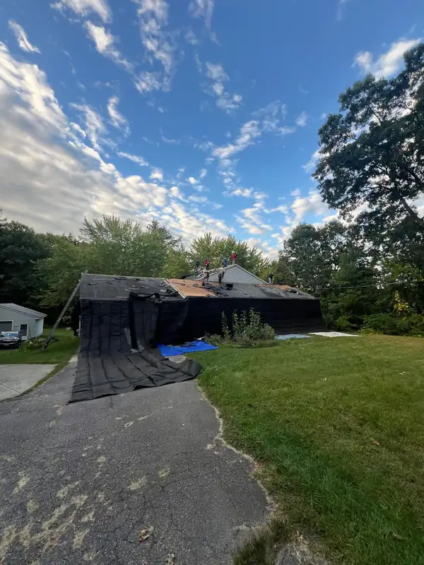 The house from the driveway, partway through the tear-off.