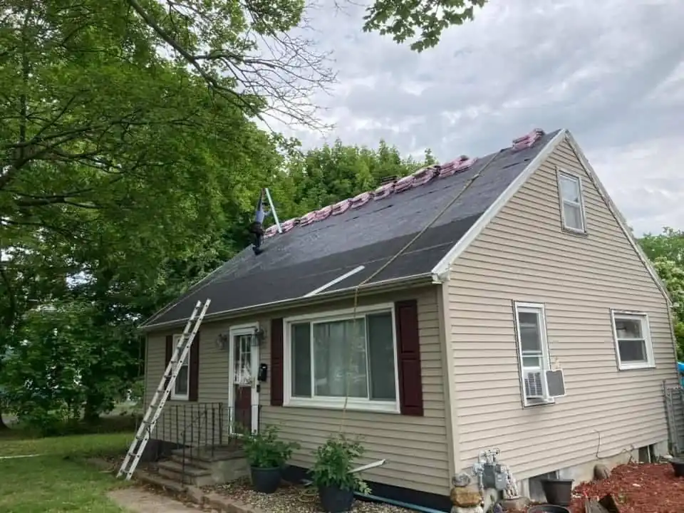 Smithfield cape mid-install, ladder up and new shingles going on